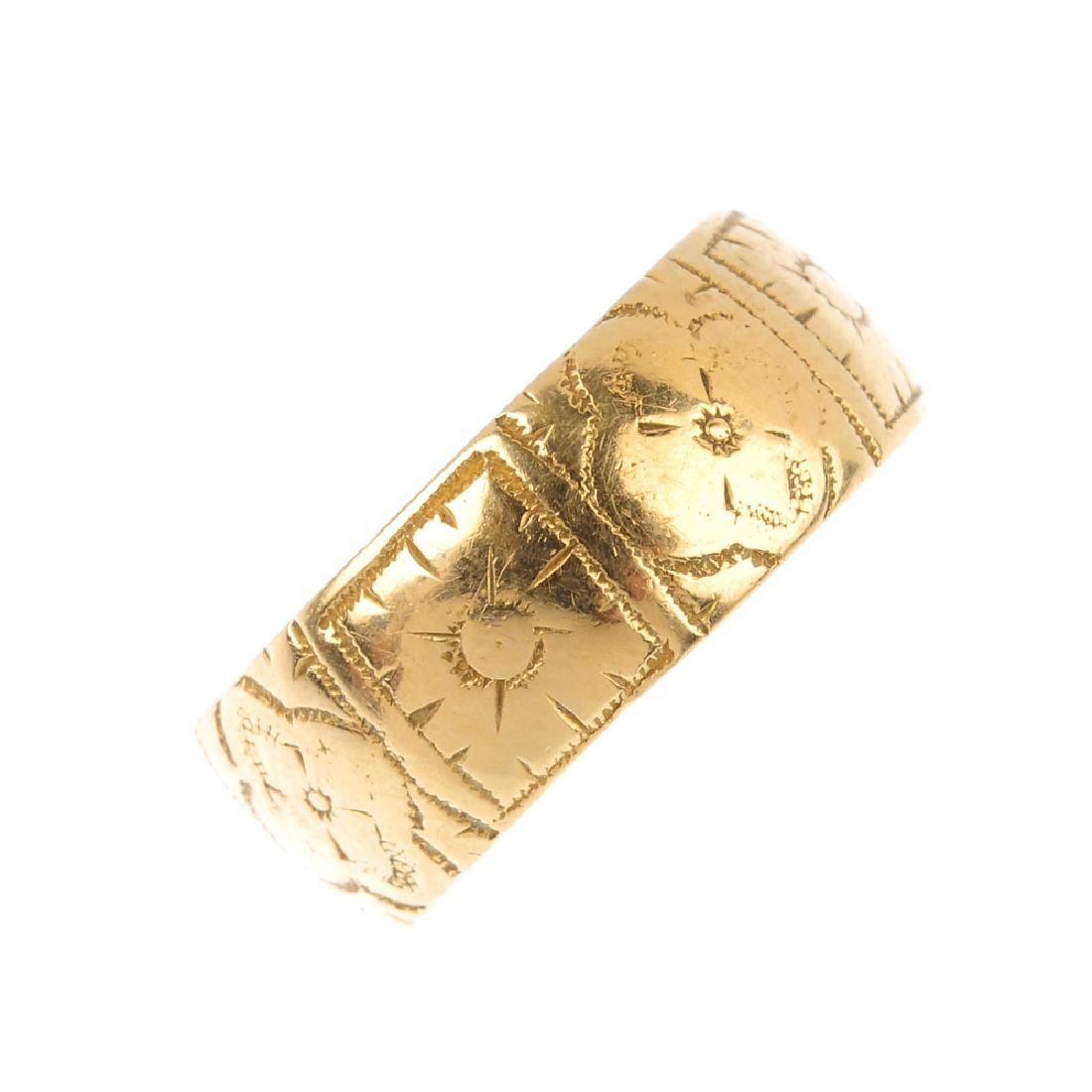 A late Victorian 18ct gold band ring. Engraved with a (1 of 3)