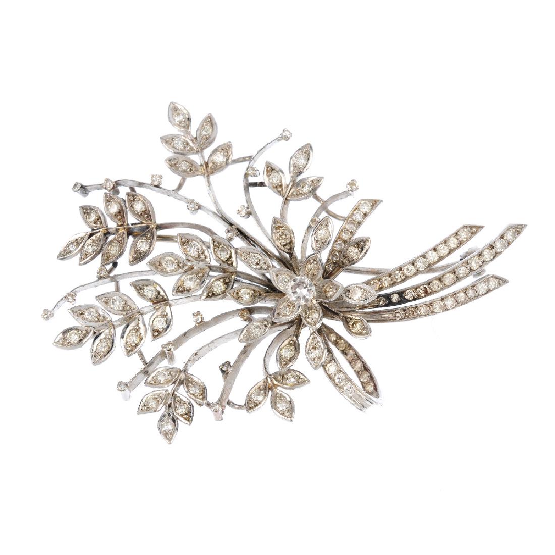 A diamond spray brooch. Of foliate design, the (1 of 2)