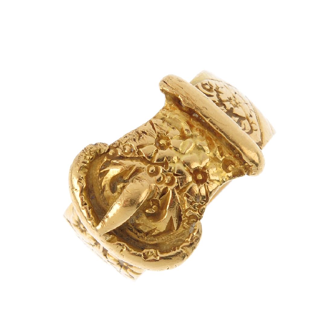 An early 20th century 18ct gold buckle ring. The floral (1 of 3)