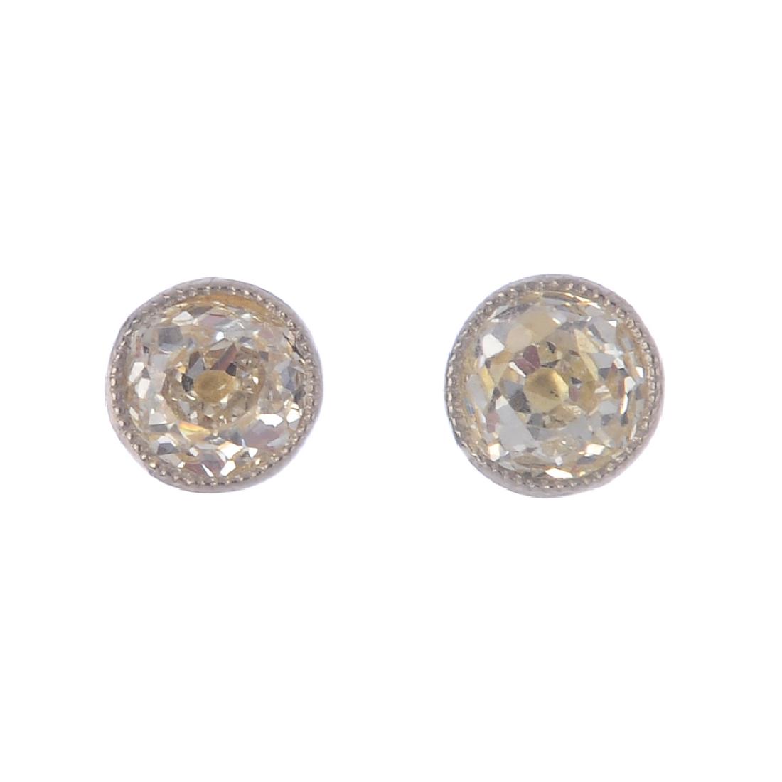 A pair of diamond stud earrings. Each designed as an (1 of 2)
