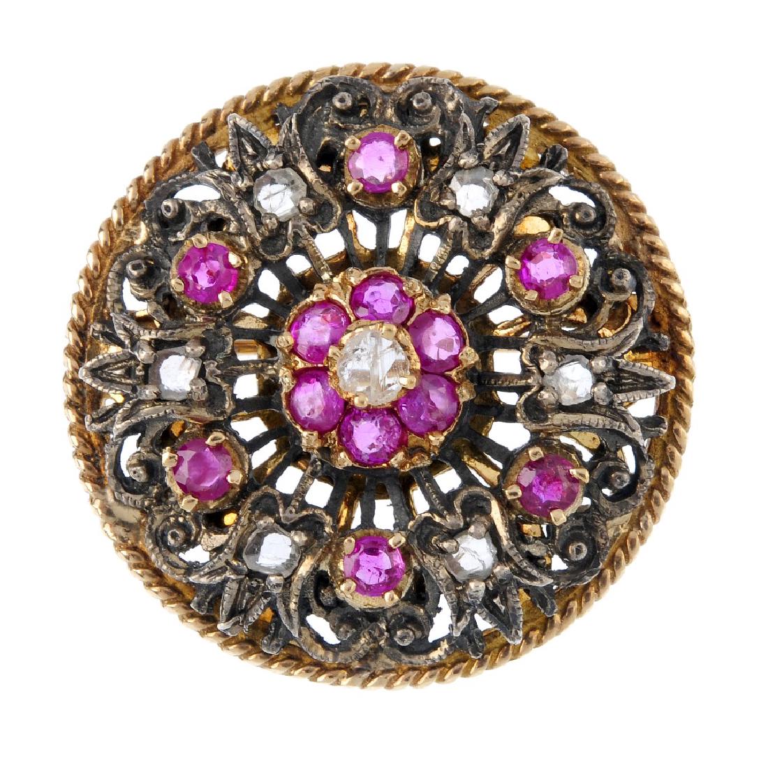 A diamond and ruby floral brooch. Of openwork design, (1 of 2)
