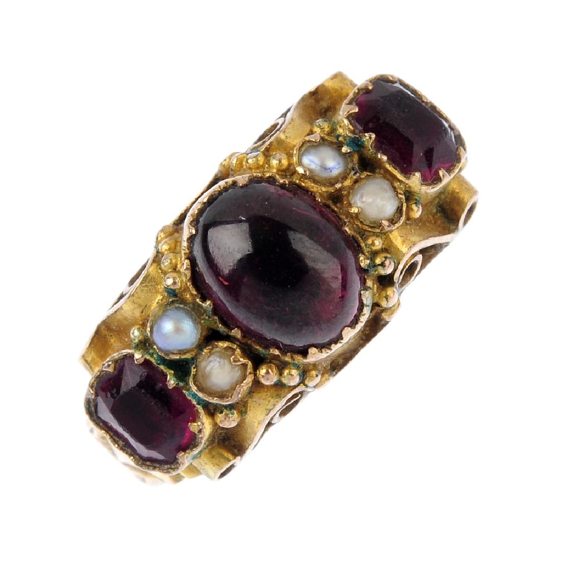 A mid Victorian 9ct gold gem-set ring. The oval garnet (1 of 3)