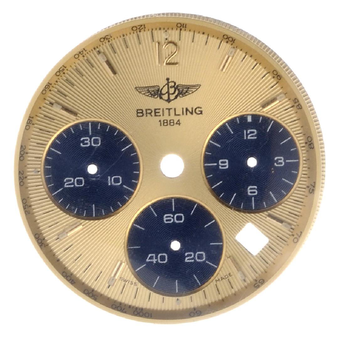 A mixed group of watch parts and items. To include a: A mixed group of watch parts and items. To include a champagne Breitling three register dial for a chronograph, Ebel dials, a Must De Cartier dial and some crowns, assorted links for Technomarine brac