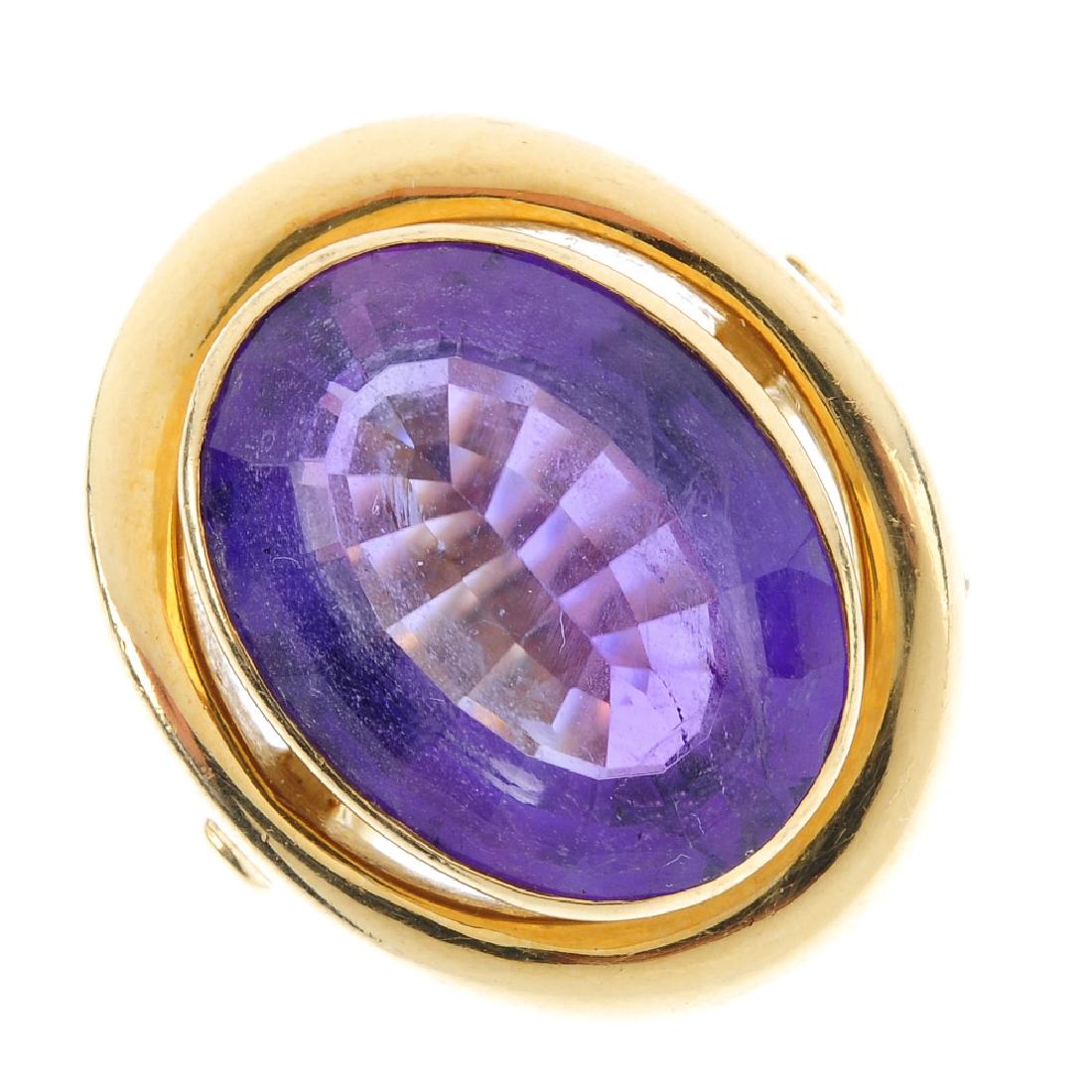 An amethyst single-stone ring. The oval-shape amethyst, (1 of 3)