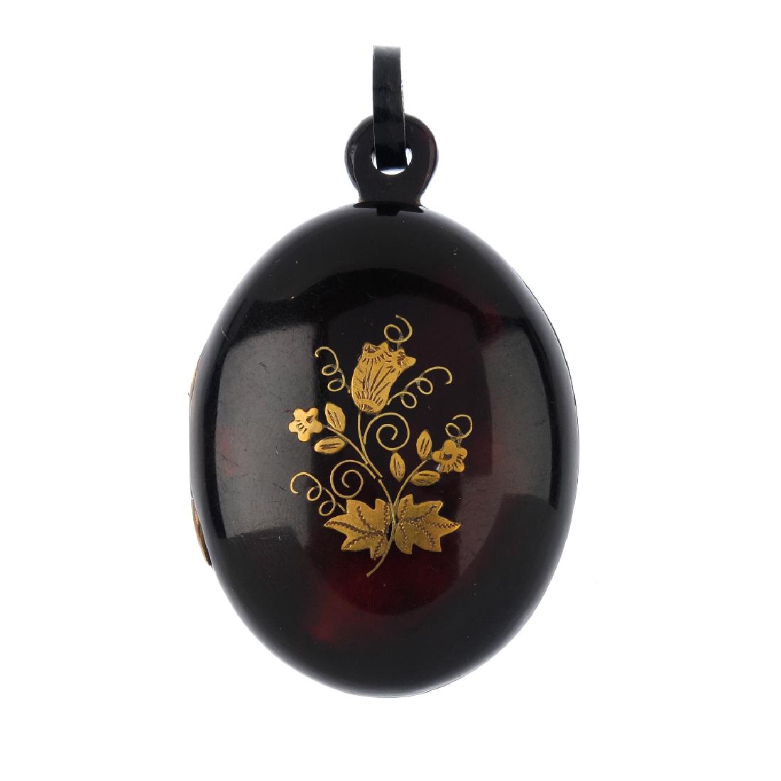A late Victorian pique tortoiseshell pendant. Of oval (1 of 2)
