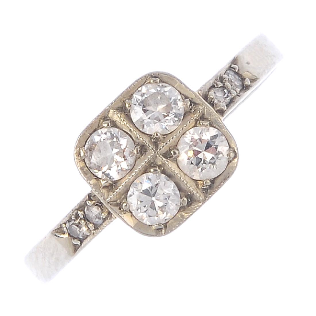A diamond dress ring. The circular-cut diamond: A diamond dress ring. The circular-cut diamond quatrefoil, with single-cut diamond shoulders. Estimated total diamond weight 0.40ct. Ring size L1/2. Weight 1.6gms.