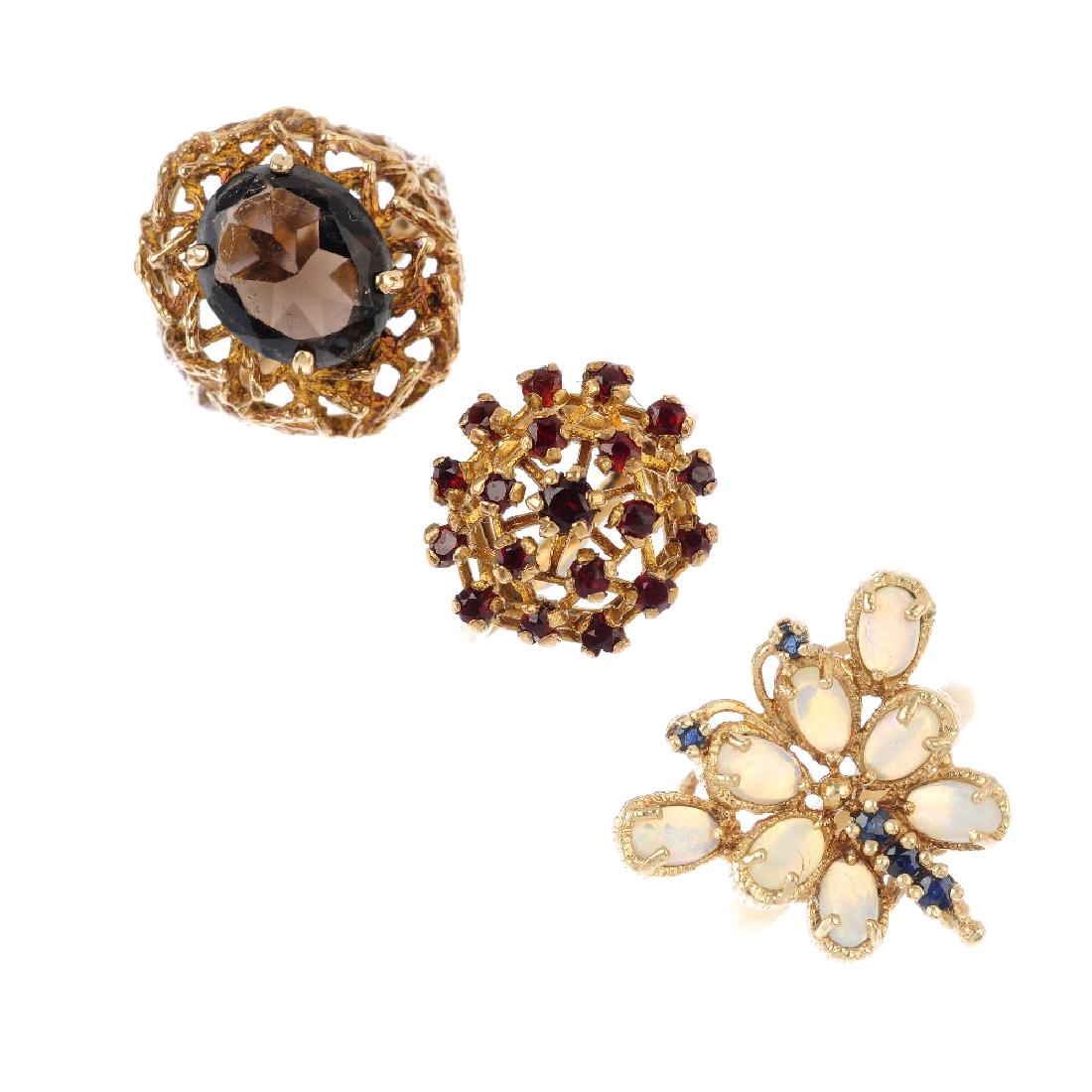 Three 9ct gold gem-set dress rings. To include a smoky (1 of 3)