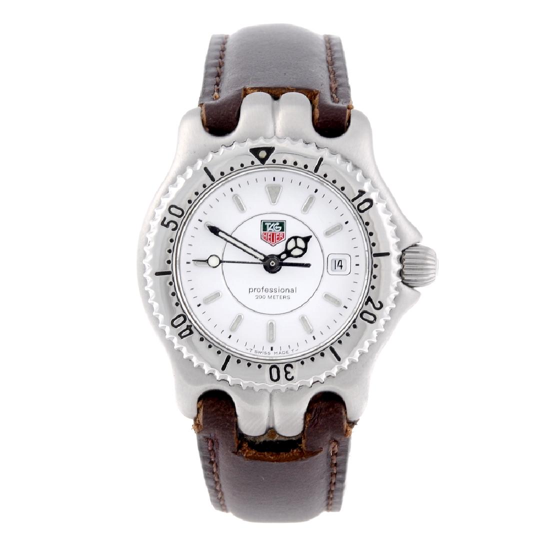 TAG HEUER - a lady's S/el wrist watch. Stainless steel: TAG HEUER - a lady's S/el wrist watch. Stainless steel case with calibrated bezel. Reference WG1312-R0, serial PY1883. Unsigned quartz movement with quick date set. White dial with luminous hour marke