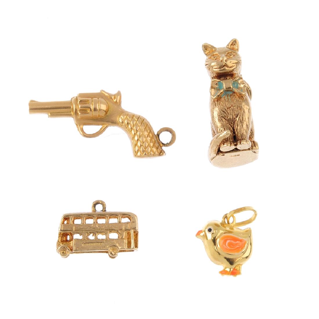 Four charms. To include a 9ct gold seated cat, a 9ct (1 of 2)