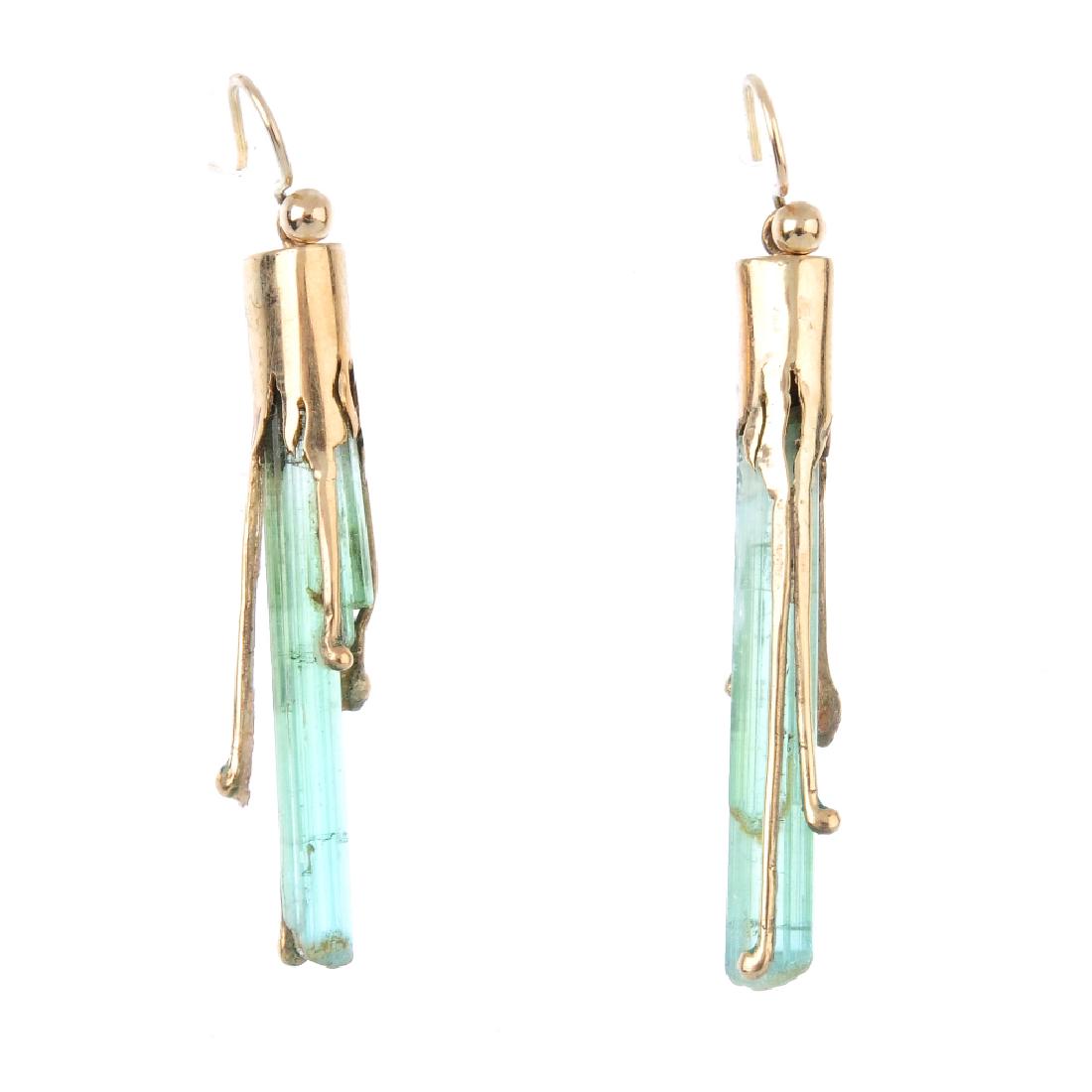 A pair of tourmaline crystal earrings. Each designed as: A pair of tourmaline crystal earrings. Each designed as an uncut tourmaline crystal, with bead terminal line and collet surmount. Length 4.4cms. Weight 4gms.