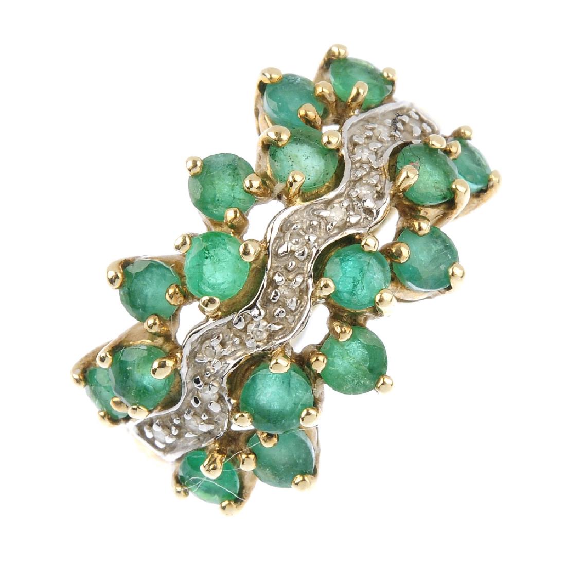 A 9ct gold emerald and diamond dress ring. The (1 of 3)