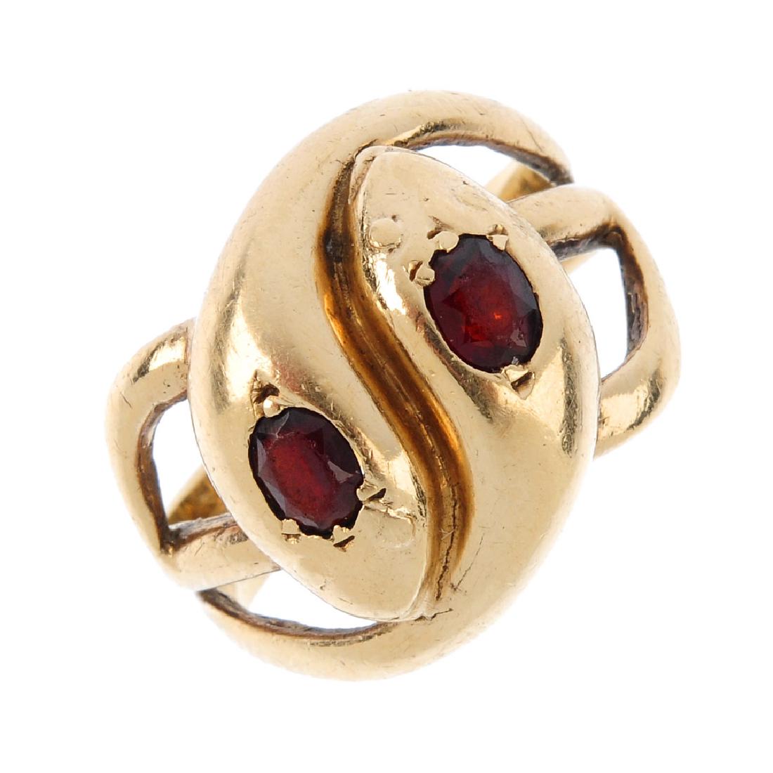 A 9ct gold garnet snake ring. Designed as two entwined (1 of 3)