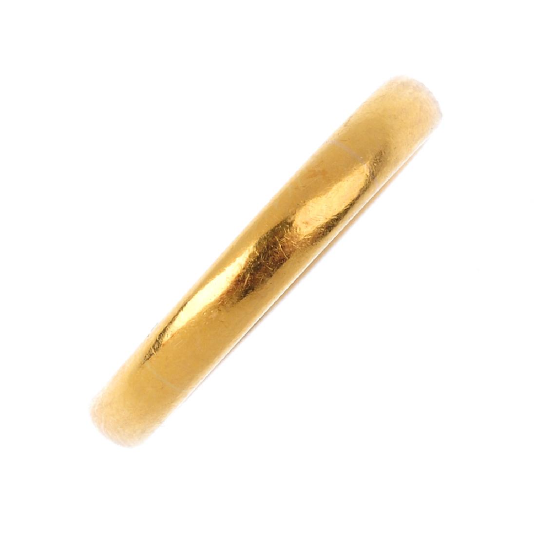A 22ct gold band ring. Hallmarks for 22ct gold, (1 of 3)