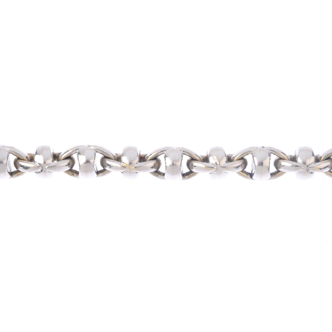 CHIMENTO - a bracelet. Designed as a series of stylised: CHIMENTO - a bracelet. Designed as a series of stylised cross and oval links, with lobster clasp. Signed Chimento. Italian marks. Length 20cms. Weight 33.3gms.