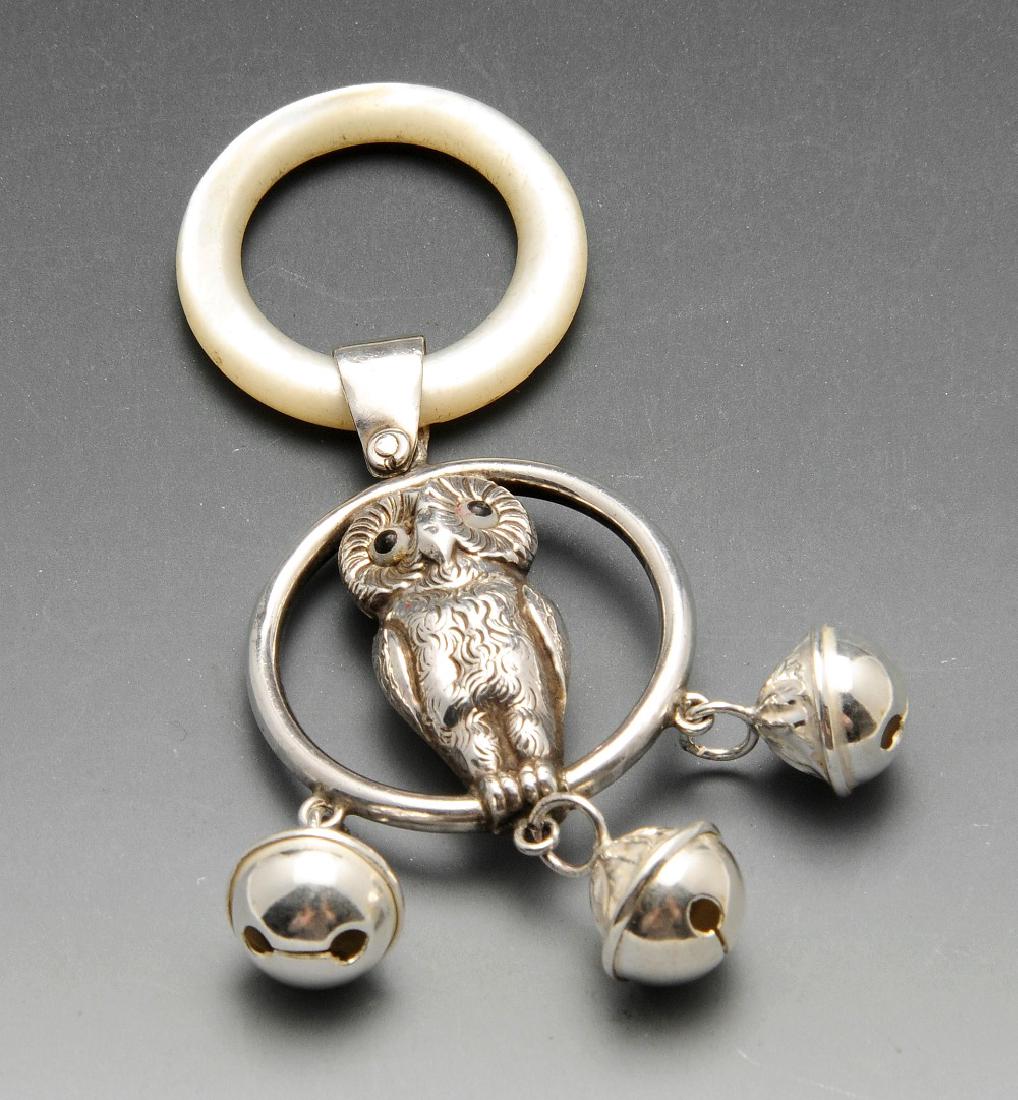 An Edwardian silver child's rattle modelled in the form (1 of 3)