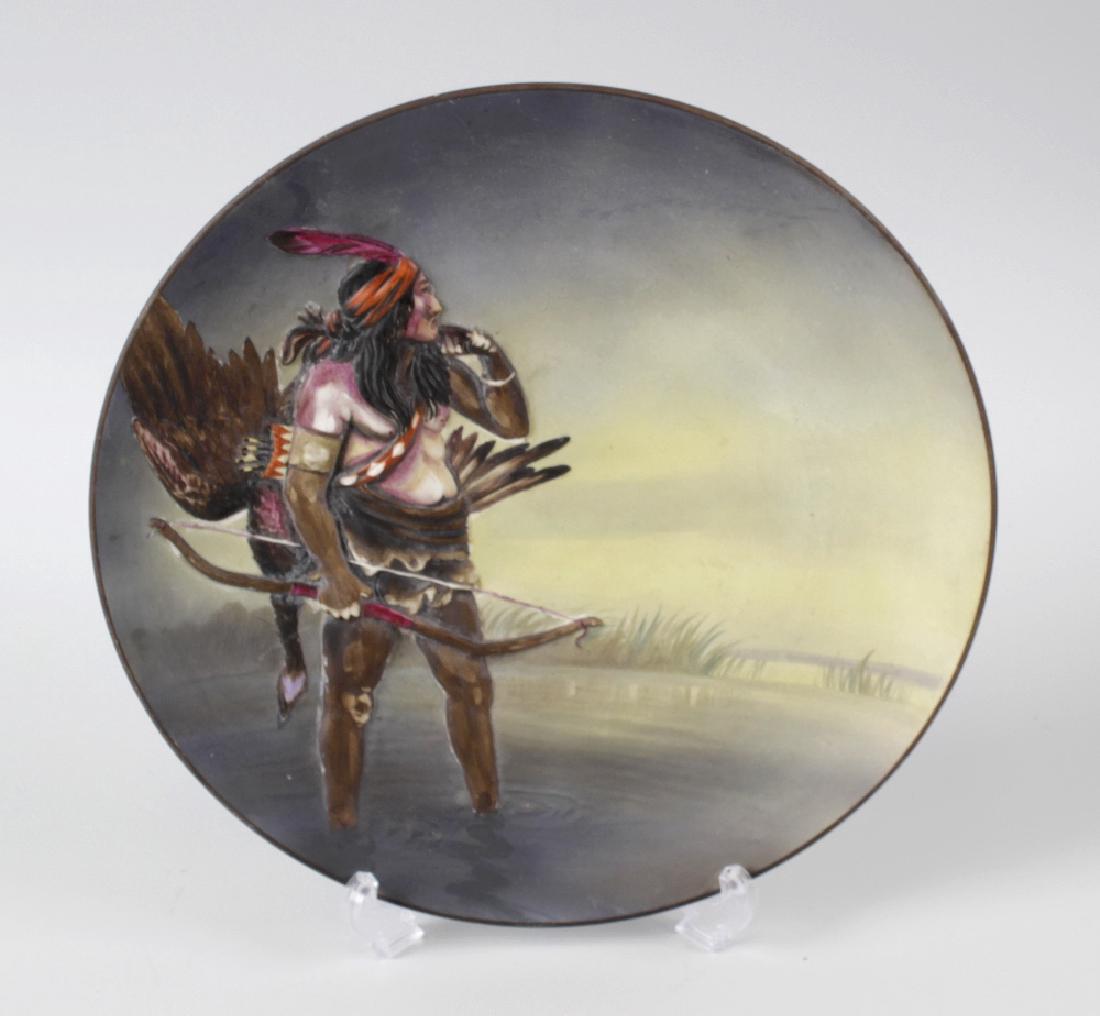 A Noritake charger, of circular form decorated in: A Noritake charger, of circular form decorated in relief with a Native American, 10.75 (27.5cm) diameter.