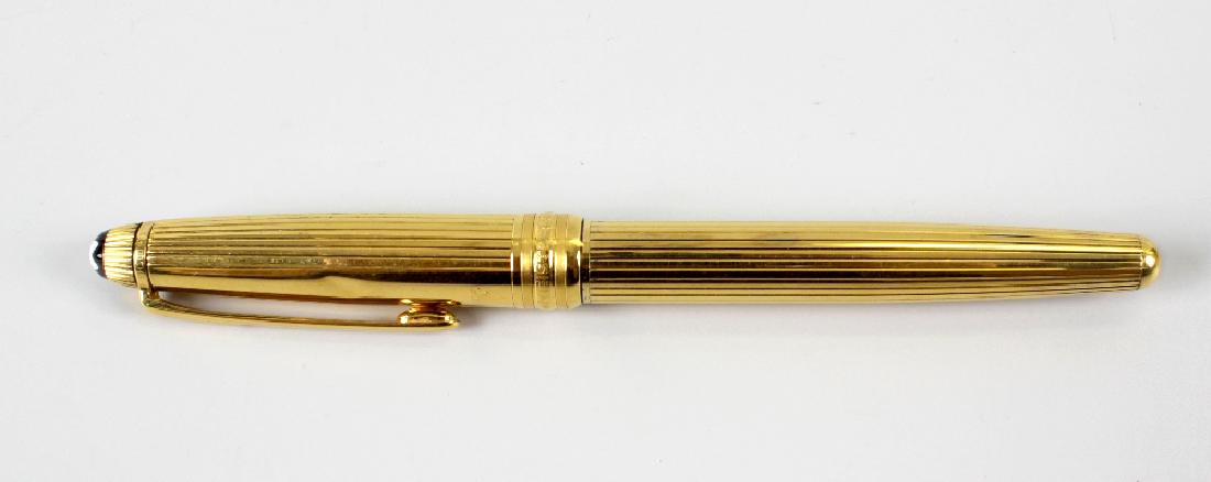 A Montblanc Meisterstuck ball point pen, the silver: A Montblanc Meisterstuck ball point pen, the silver gilt body stamped 925 with machine turned banded decorated and domed terminal with white star emblem, 5.5 (14cm) long.