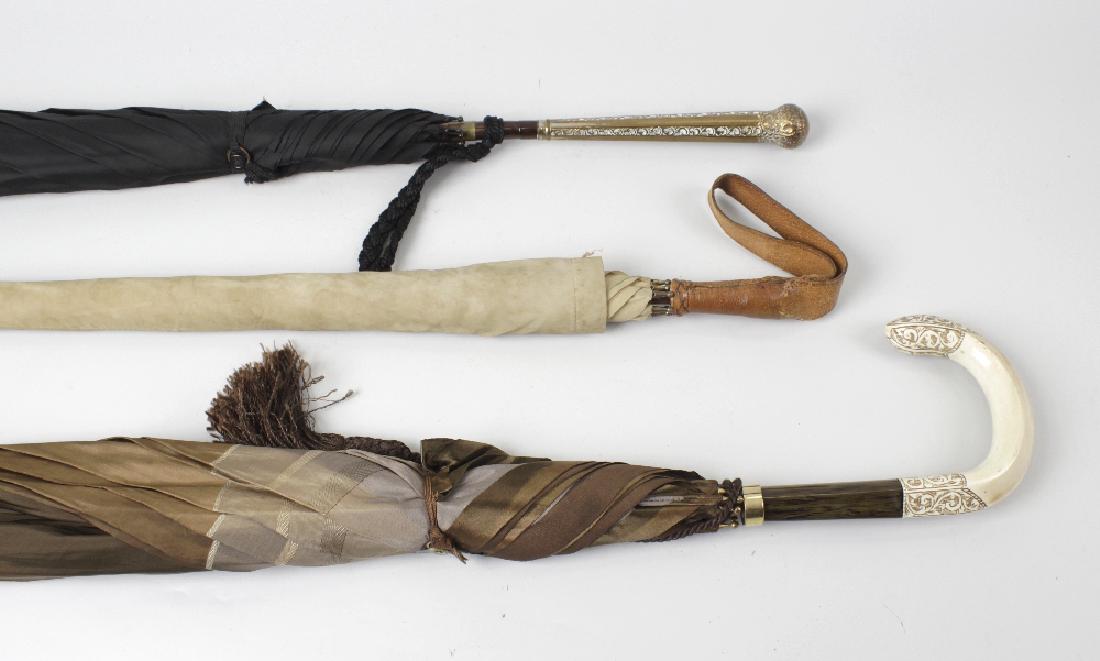 A group of eleven assorted umbrellas/parasols. To: A group of eleven assorted umbrellas/parasols. To include an ivory-handled example, two horn, one silver-plated, and seven others, (11).