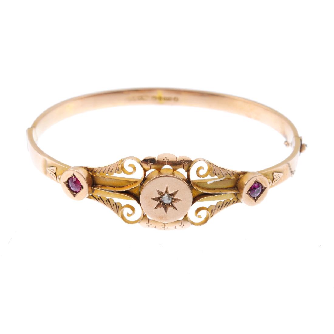 An early 20th century 9ct gold ruby and diamond hinged (1 of 2)