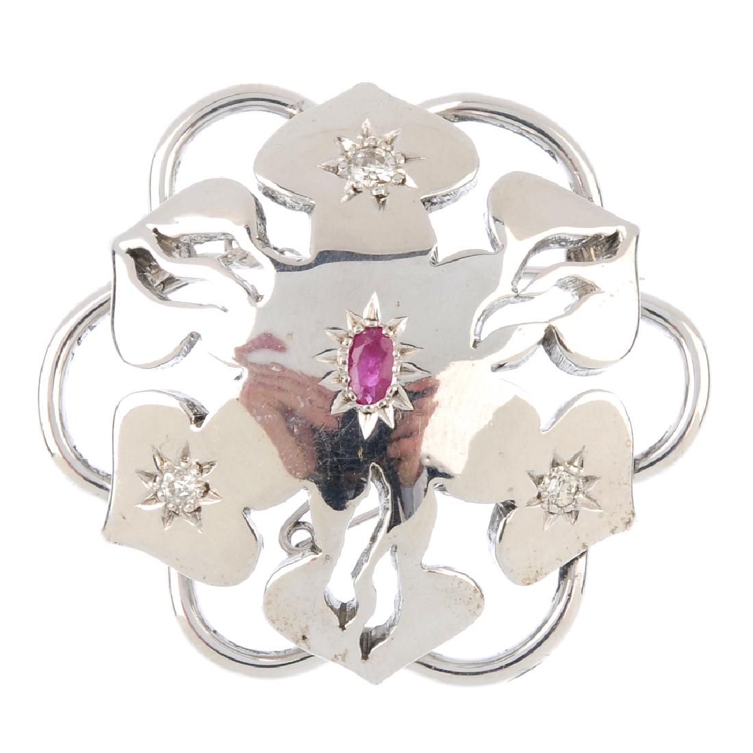A diamond and ruby brooch. Of stylised floral design, (1 of 2)