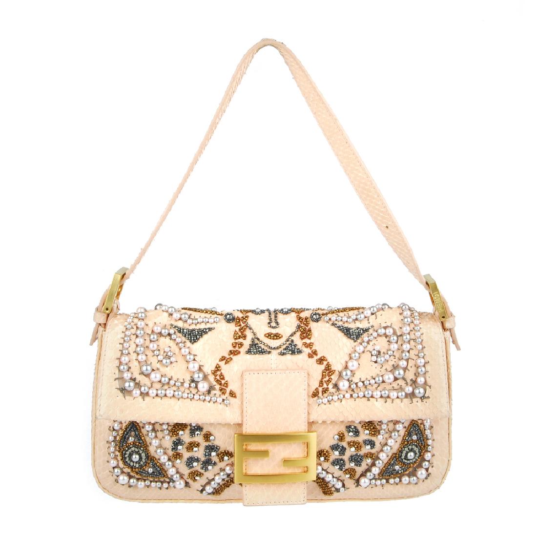 FENDI - a limited edition runway Queen baguette: FENDI - a limited edition runway Queen baguette handbag. Featuring a pink snakeskin exterior, with rhinestone, pearl and bead embellishments abstractly depicting a crowned Queen, with a single flat to