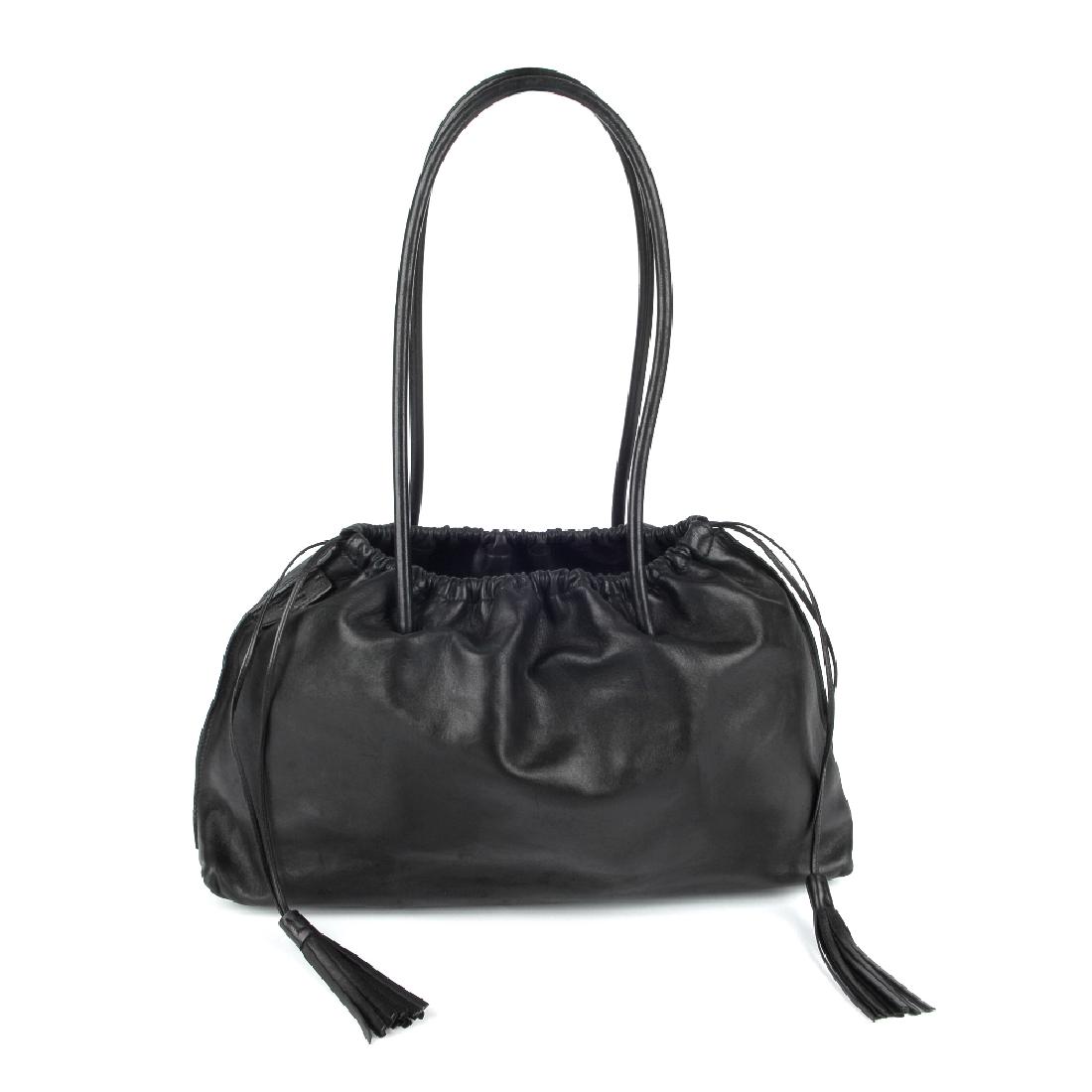GUCCI - a black leather handbag. Crafted from soft (1 of 5)