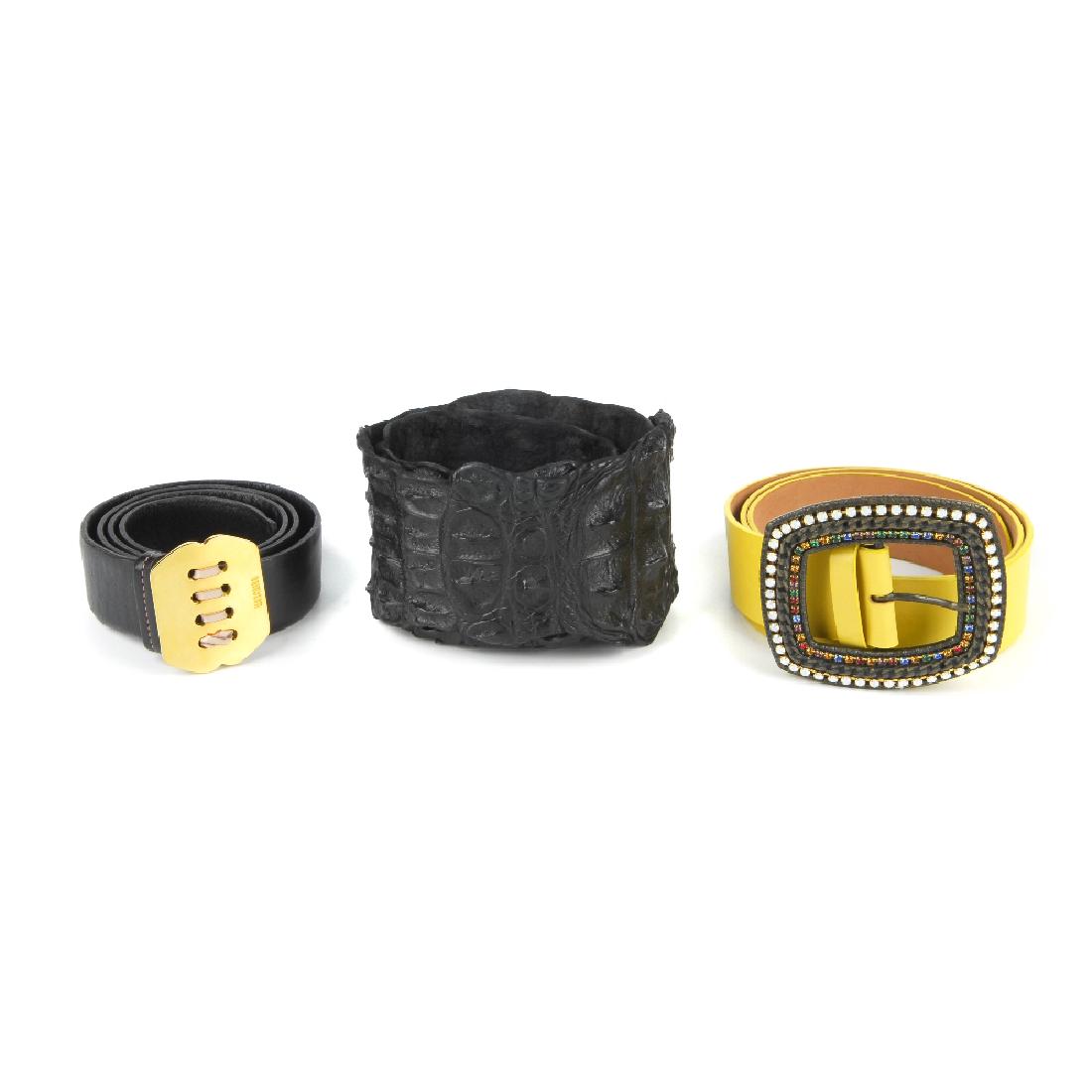 Three designer belts. To include a yellow leather belt: Three designer belts. To include a yellow leather belt by Etro, featuring an oversized embellished buckle fastening, a black leather belt by Moschino and a black hornback crocodile leather belt by Ple