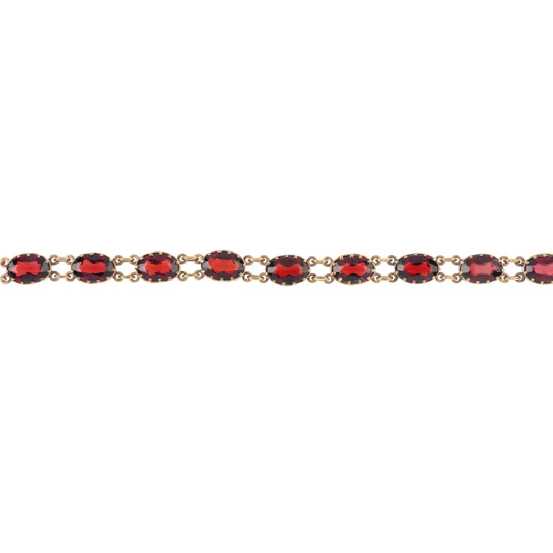 A 9ct gold garnet bracelet. Designed as a series of (1 of 5)