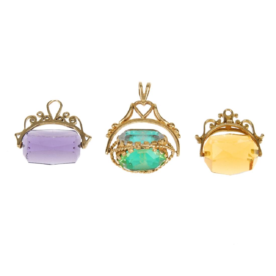Three 9ct gold swivel fobs. The first set with a purple (1 of 2)
