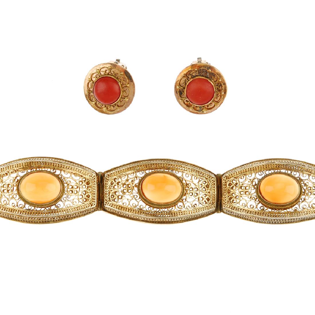 A Chinese agate bracelet and a pair of coral ear clips.: A Chinese agate bracelet and a pair of coral ear clips. The bracelet of barrel-shape wirework links, each set with an oval-shape Chinese agate cabochon, to the push-piece clasp, together with circular
