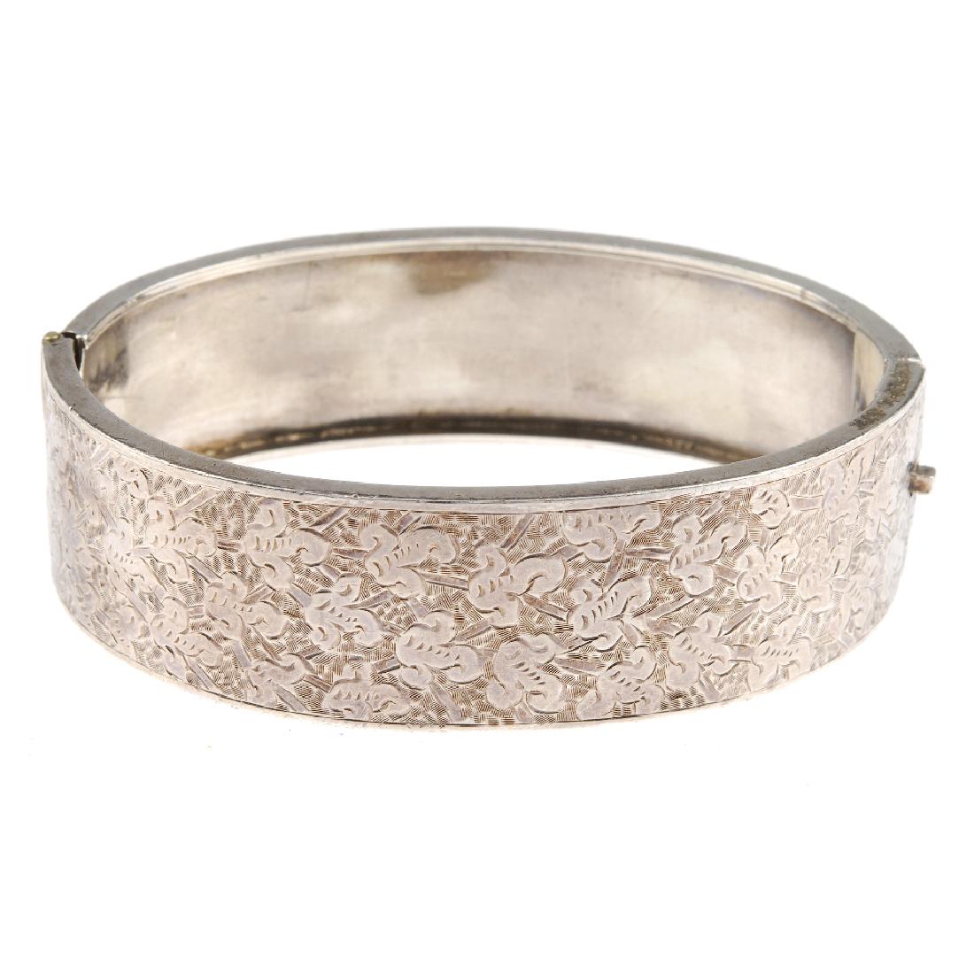 Four hinged bangles. All with engraved floral or leaf (1 of 4)