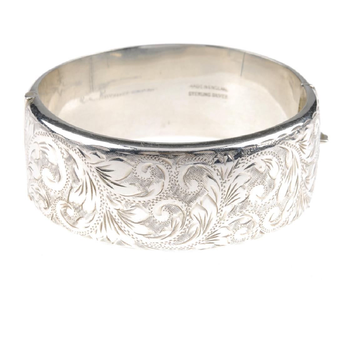 Four hinged bangles. Two with engraved scrolling (1 of 4)