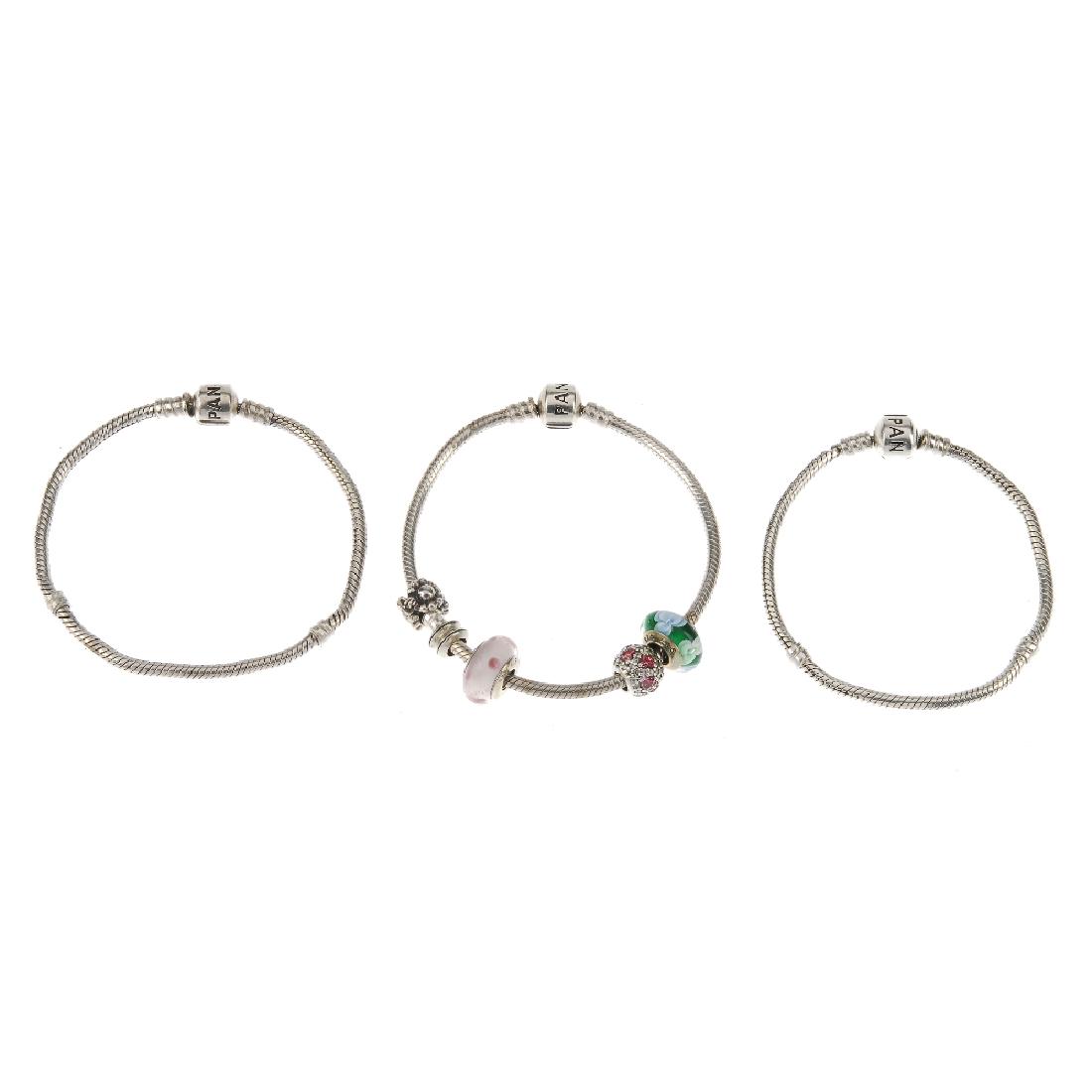 PANDORA - three bracelets, four charms and two spacers. (1 of 2)