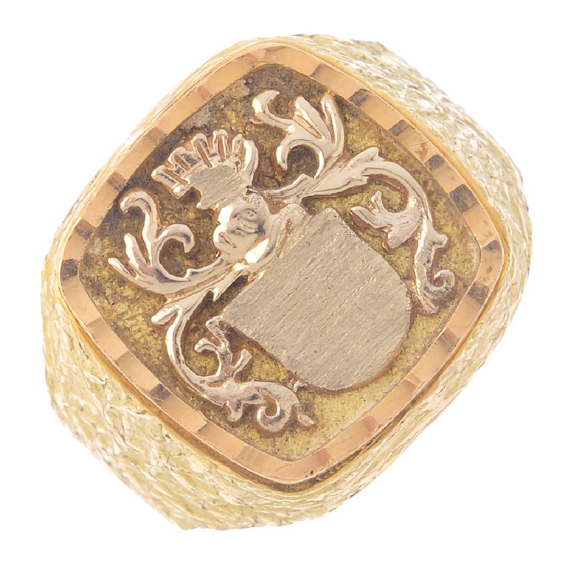 A gentleman's signet ring. The square panel depicting a: A gentleman's signet ring. The square panel depicting a coat-of-arms, with textured surround. Ring size U1/2. Weight 10.7gms.