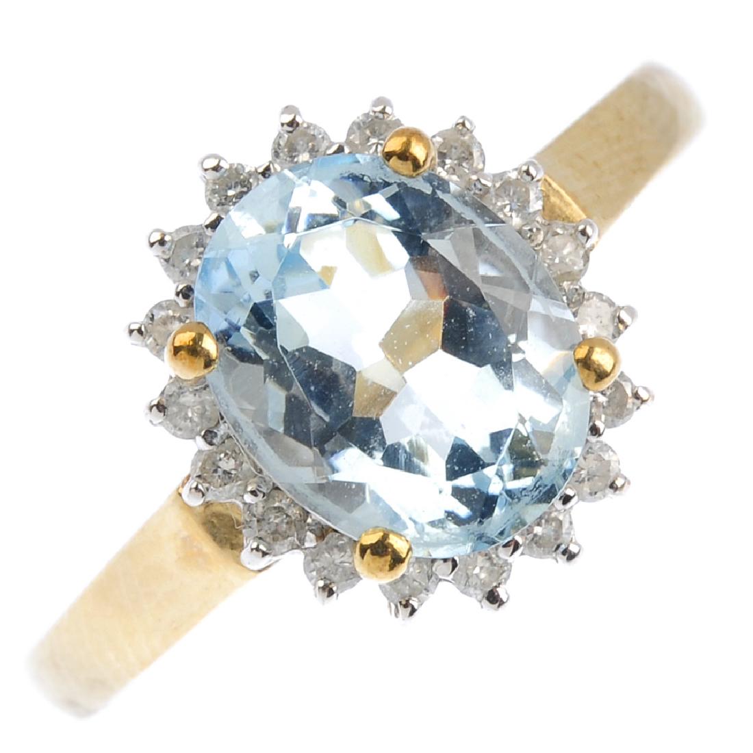 A 9ct gold aquamarine and diamond cluster ring. The (1 of 3)