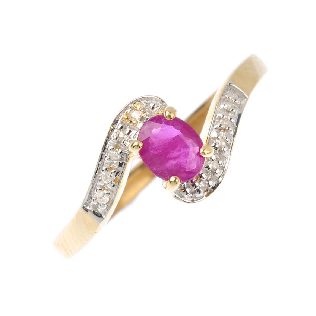 A 9ct gold ruby and diamond ring. The oval-shape ruby, (1 of 3)