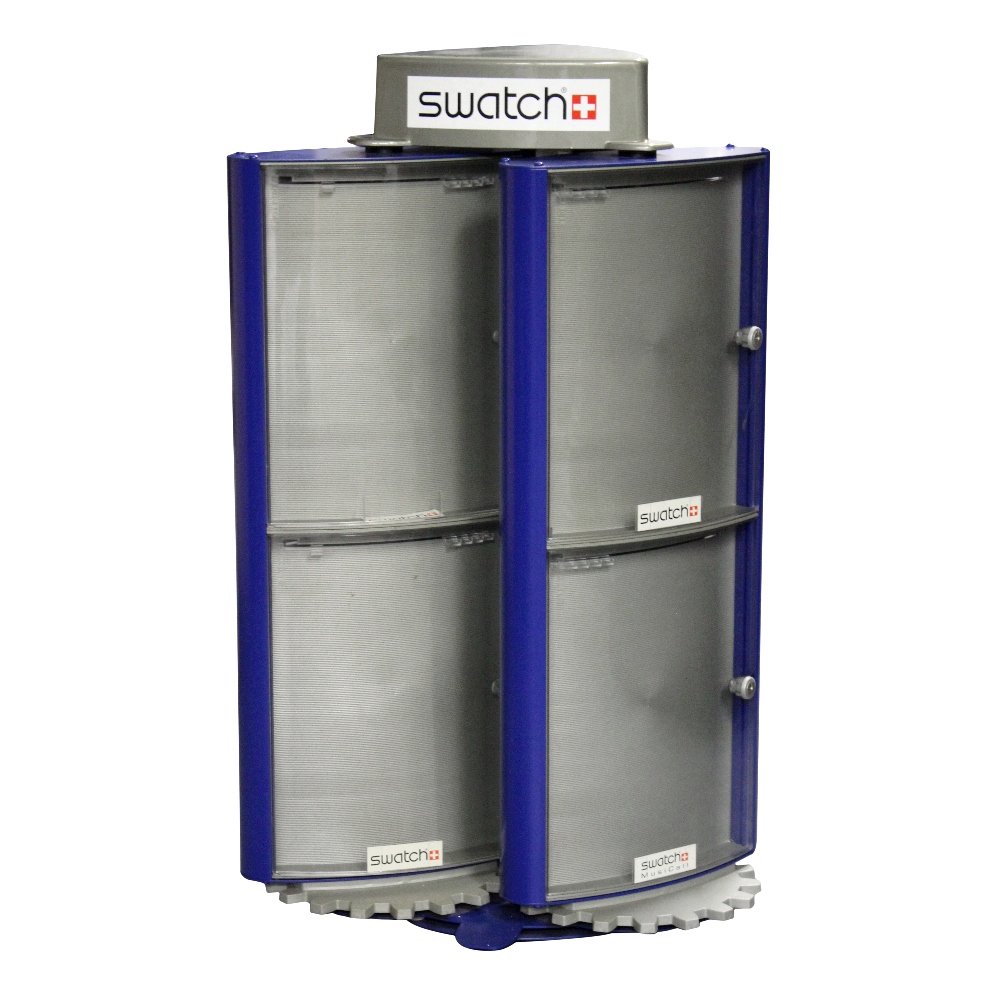 A mixed group of Swatch display items, to include a met: A mixed group of Swatch display items, to include a metal locking Swatch tower cabinet, a plastic three-part revolving Swatch display stand, and a square, revolving Swatch display stand.