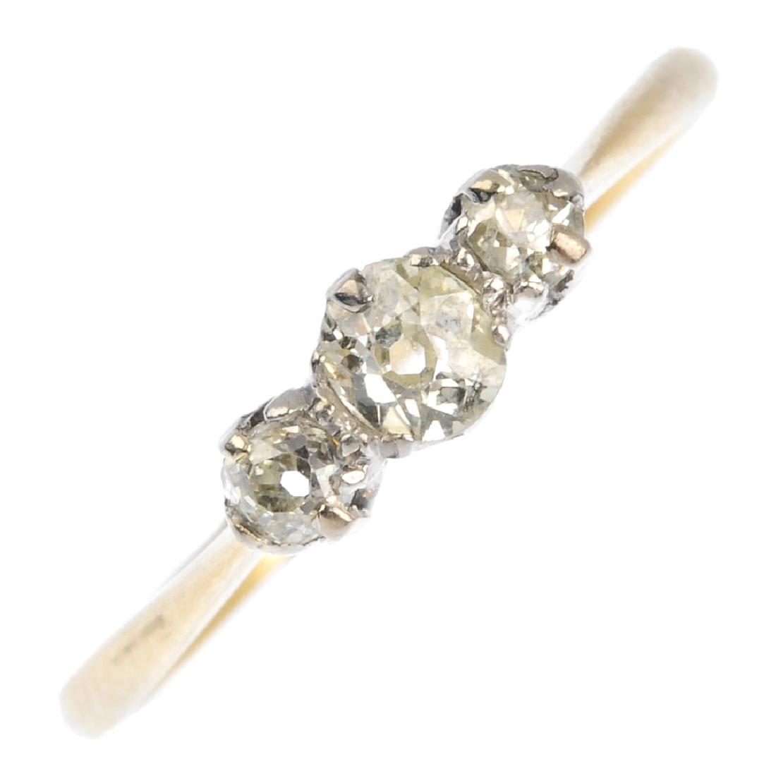 A diamond three-stone ring. The old-cut diamond line, (1 of 3)