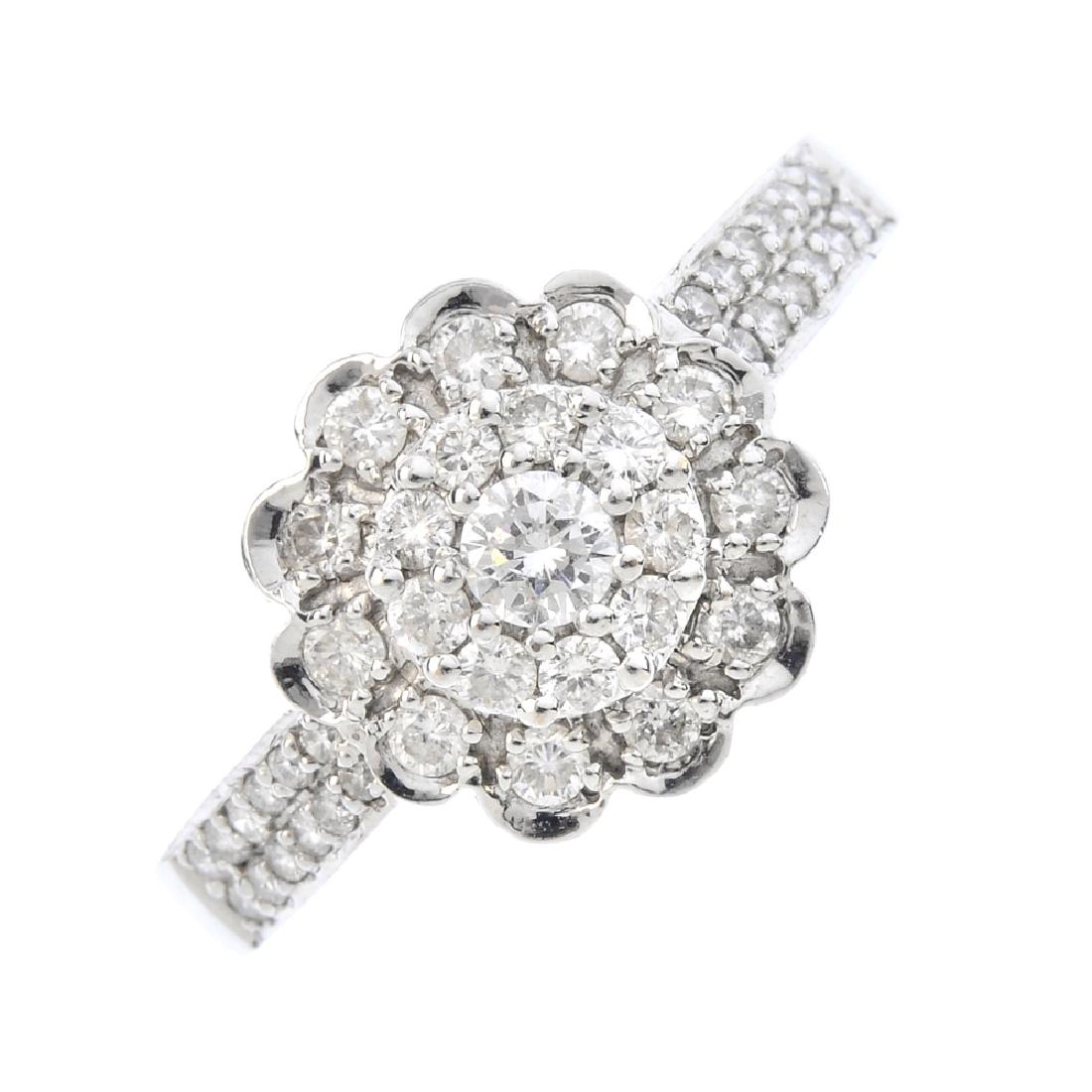 An 18ct gold diamond cluster ring. The brilliant-cut (1 of 3)