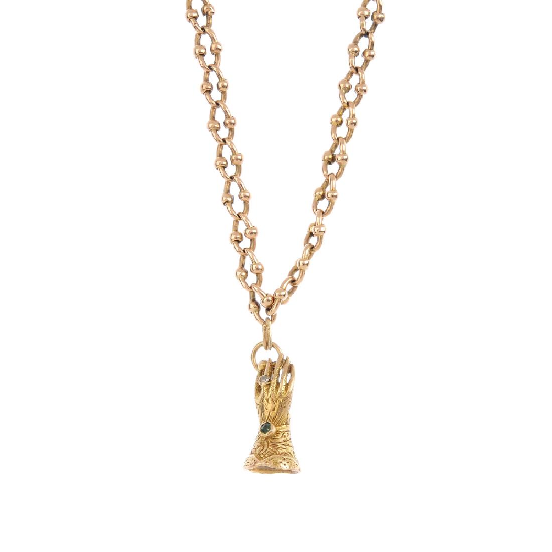 A chain and 9ct gold charm. The charm designed as a (1 of 3)