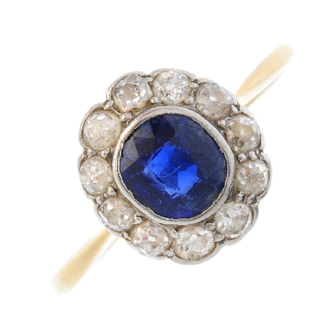 A sapphire and diamond cluster ring. The cushion-shape (1 of 3)