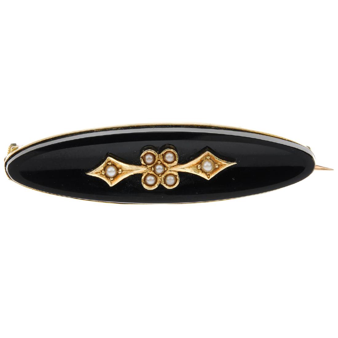 A late 19th century gold onyx and split pearl brooch. (1 of 2)