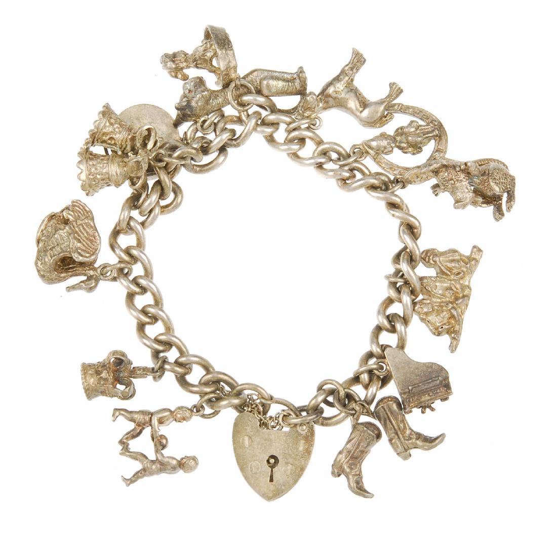 Two charm bracelets. The curb-link bracelets with heart: Two charm bracelets. The curb-link bracelets with heart padlock clasps, suspending a total of twenty-two charms to include a cable car and a lobster basket. Lengths 16 to 18cms. Weight 127gms.