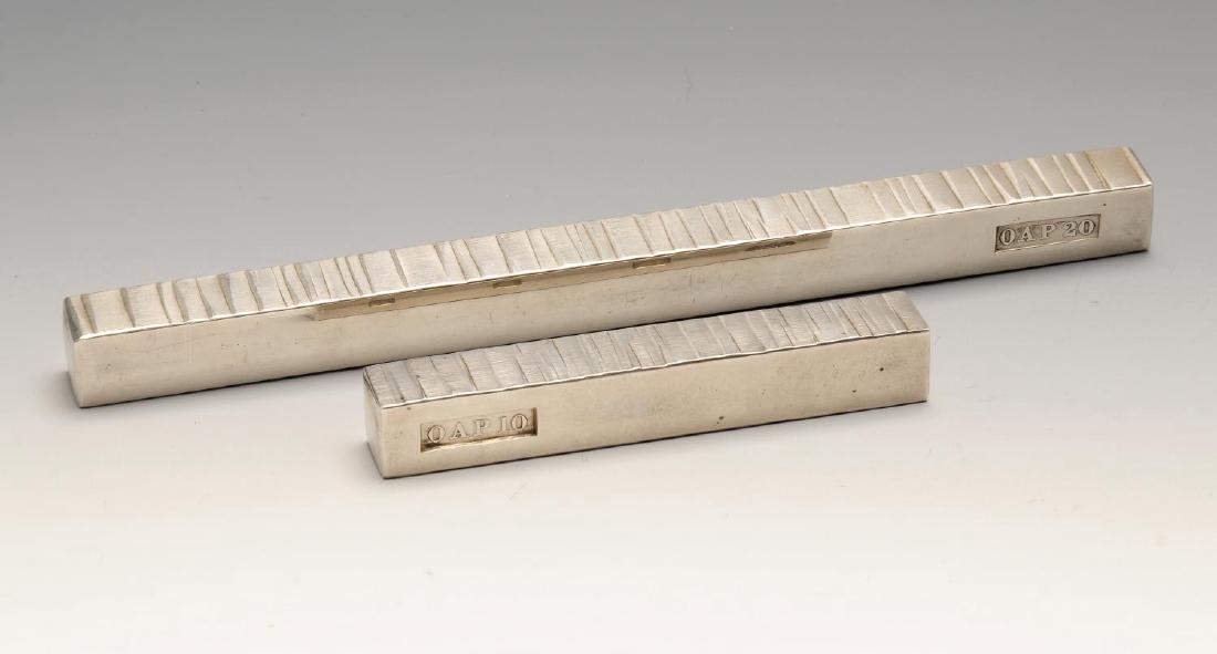 Two modern silver paperweights by Gerald Benney, of: Two modern silver paperweights by Gerald Benney, of graduated size and with textured decoration. Hallmarked Gerald Benney, London 1971 and 1981, also marked OAP 20 and OAP 10. Lengths measuring 8 inch