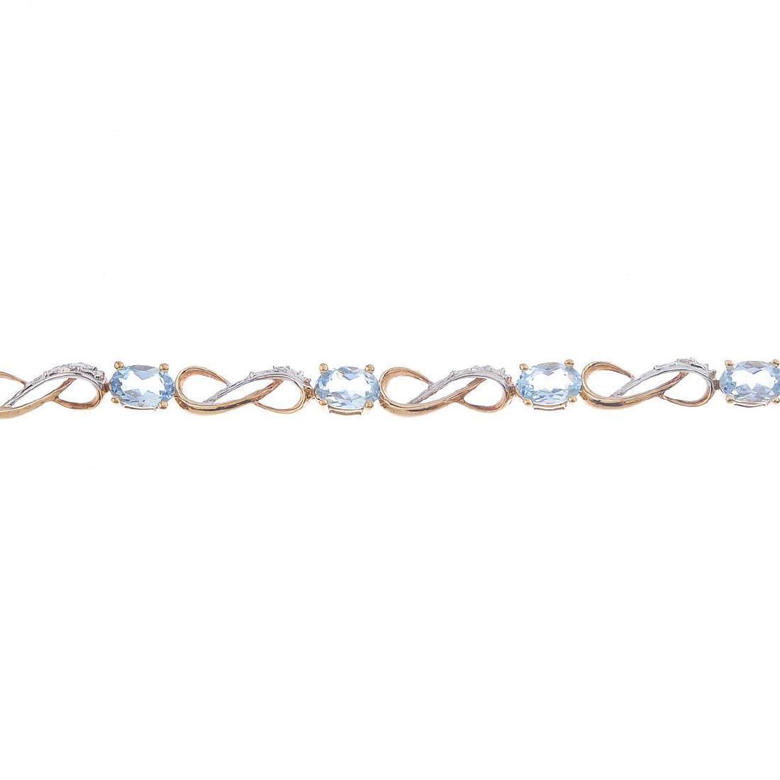 A 9ct gold topaz and diamond bracelet. Of bi-colour (1 of 3)
