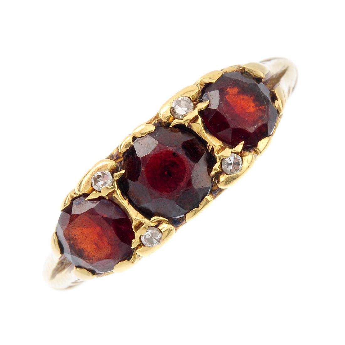 An 18ct gold garnet and diamond ring. The (1 of 3)