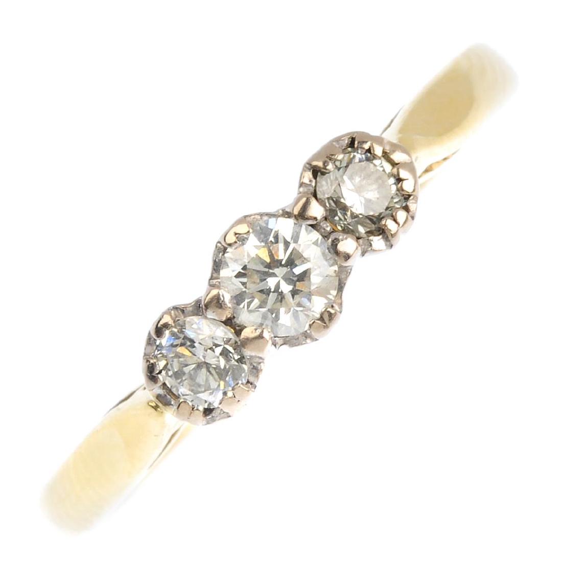 An 18ct gold diamond three-stone ring. The graduated (1 of 3)