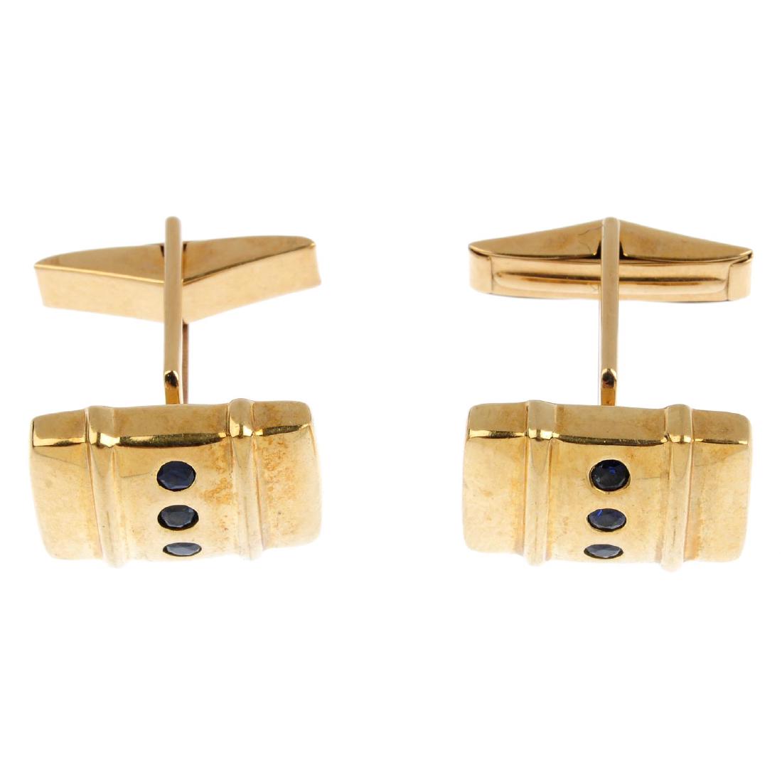 A pair of 9ct gold sapphire cufflinks. Each designed as (1 of 2)