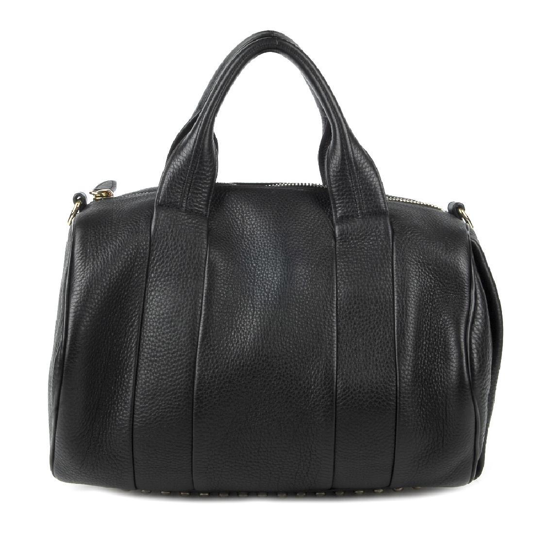 ALEXANDER WANG - a Rocco leather handbag. Featuring a: ALEXANDER WANG - a Rocco leather handbag. Featuring a black pebbled leather exterior adorned with pale gold-tone base studs, with dual leather top handles, a detachable leather shoulder strap, top zip