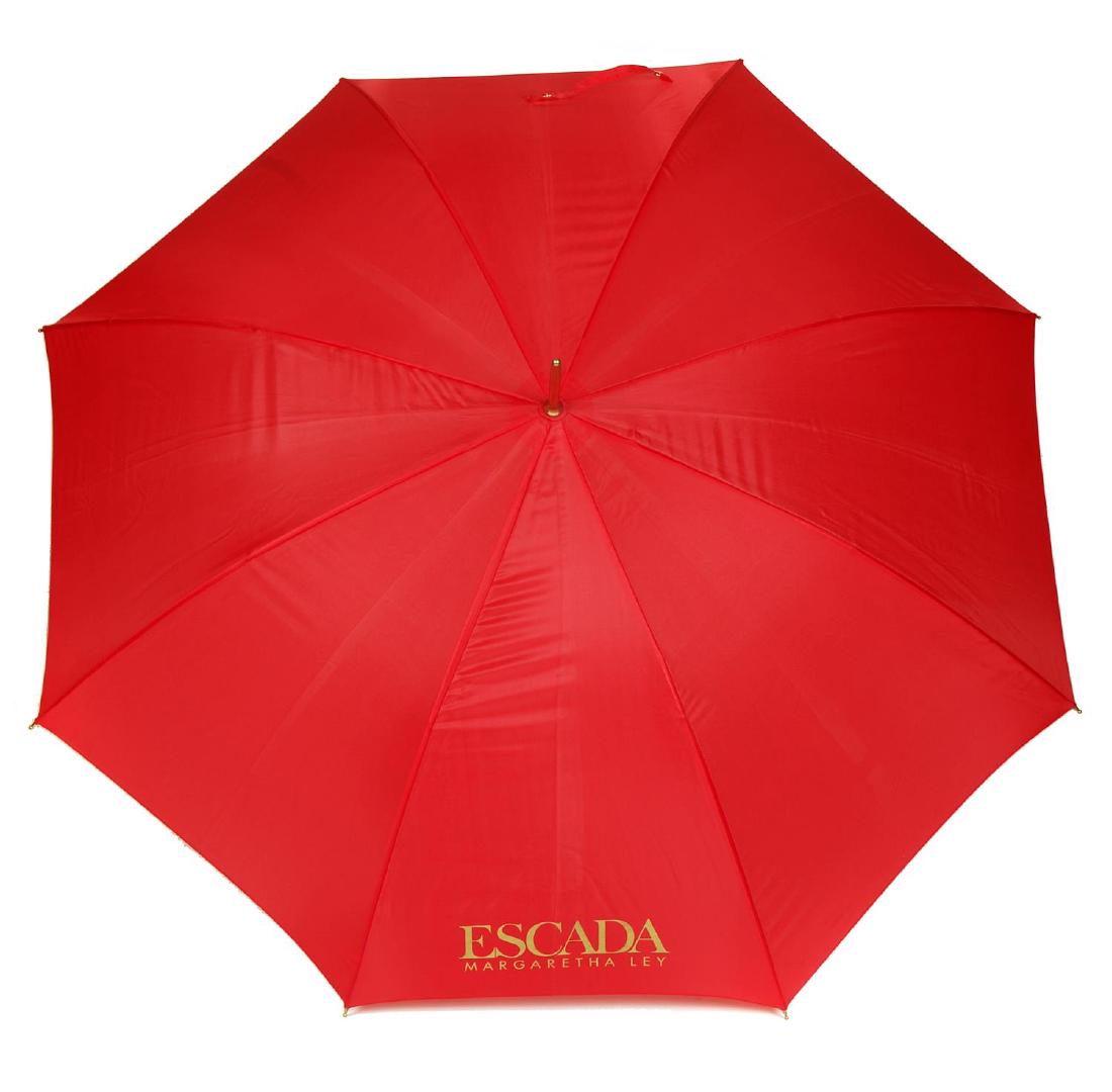 ESCADA - three umbrellas. To include two lightweight: ESCADA - three umbrellas. To include two lightweight walking umbrellas, one with a red canopy, one with a cream canopy, with wooden shafts and crook handles, together with a retractable umbrella, with